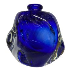 a blue glass vase sitting on top of a table