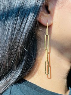 Say hello to these impressive Paperclip Chain Earrings that are exclusively handcrafted. Our dangling earrings will suit even the most minimalist woman; a simple geometric design comes together to create these statement pieces. Paperclip Chain Earring Details: Metal: 14K Gold Plated on Stainless Steel Hypoallergenic, Tarnish-Free. Length: 8.5cm Perfect your Parure by pairing with our Zirconia Pendant Necklace and Single Diamond Bezel Bracelet. Gold Paperclip Shape Single Earring, Gold Single Paperclip Earring, Gold Paperclip Shaped Single Earring, Modern Paperclip Earrings For Pierced Ears, Modern Paperclip Earrings For Everyday, Modern Paperclip Everyday Earrings, Modern Link-style Earrings With Box Chain, Gold Paperclip Earrings For Everyday, Gold Paperclip Chain Earrings For Formal Occasions