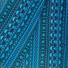 a blue and green cloth with designs on it