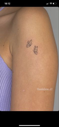 a woman's arm with two butterflies on it, and the back of her shoulder