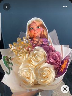 a bouquet of flowers with a doll in the middle and a sticker on it