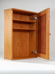 an open wooden cabinet on a white background