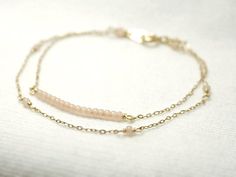 Double strand beaded bar bracelet - dainty jewelryTiny baby pink beads beaded on 14K gold filled chain.  Double chain bracelet that's femininely dainty in soft shades of gold and blushing pink.  >>>measurements<<<bead bar length 1"please choose length at checkout♦you can enter shop here!http://etsy.com/shop/illusy Dainty Rose Gold Beaded Bracelets, Delicate Beaded 14k Gold-filled Bracelets, Dainty Pink Gold Jewelry For Everyday, Dainty Rose Gold Jewelry With Tiny Beads, Dainty 14k Gold Beaded Bracelets, Dainty Rose Gold Beaded 14k Gold Bracelets, Dainty 14k Rose Gold Beaded Bracelets, Delicate Beaded Bracelets With Satellite Chain, Dainty Pink Bracelets With Adjustable Chain