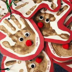 handprinted christmas ornaments with red pom - poms