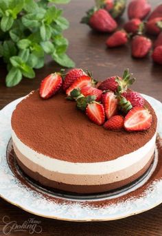 there is a chocolate cake with strawberries on top