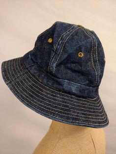 "Well made and well loved classic bucket hat by Levi's. Vintage seventies. Condition very good, light wear from age but no damage, no stains. Stiffness to fabric, yellowing on sweatband. Dark wash cotton denim, ochre stitching. Copper color button on top with lettering Levi Strauss &Co SFCAL. Cotton. 2.25\" brim. inside circumference 22.5\", not stretchy but a bit of give. wt 5oz" Retro Wide Brim Bucket Hat, Retro Blue Bucket Hat, Retro Blue Bucket Hat With Curved Brim, Blue Retro Bucket Hat With Curved Brim, Vintage Cotton Sun Hat With Curved Brim, Vintage Cotton Hat With Curved Brim, Vintage Cotton Bucket Hat, Vintage Blue Hat With Curved Brim, Vintage Cotton Wide Brim Sun Hat