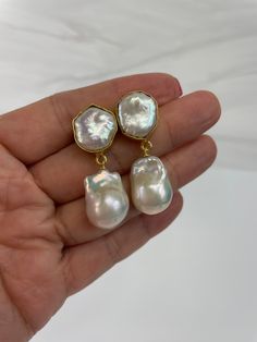 Gorgoeus baroque pearl earrings!  The actual pair on the listing has been sold. This is custom ordered.  This handmade Baroque Pearl earrings is classic and elegant.  The Baroque or flameball cultured freshwater dangling pearls are large 14mm to 15mm x 20mm to 21mm,  white, lustrous, AAA quality, attached to a gold filled bail/peg.  The ear finding is a beautiful 22k gold plated freshwater baroque Pearl, bezeled, brass body. Comes with large ear nuts.    Just simply gorgeous, great for weddings, Formal Baroque Pearl Earrings, Elegant Baroque Pearl Earrings In Pearl White, Elegant Baroque Pearl White Pearl Earrings, Formal Baroque Pearl Chain Earrings, Party Pearl Earrings With Baroque Pearl Pendant, Elegant Baroque Pearl Earrings In Pear Shape, Baroque Pearl Earrings With Pearl Pendant For Party, Party Baroque Pearl Earrings With Pearl Pendant, Baroque Pearl Drop Bridal Earrings