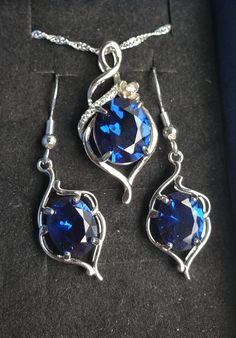 "Brilliant Deep Blue Sapphire Necklace And Earrings, 10x12mm And 8x10mm Simulated Lab Created Gems, 925 Sterling Silver Pendant, Rhodium Plated,  Cubic Zirconia Pave' Trim,18\" Sterling Chain. Chain Length Options Available By Messaging Seller At Time Of Purchase. Matching 925 Sterling Earrings, Rhodium Plated, Ear Wire Style. Gift Box Included." Silver Sapphire Dangle Jewelry, Sterling Silver Blue Necklace With Matching Earrings, Blue Sterling Silver Necklace With Matching Earrings, Formal Sapphire Sterling Silver Jewelry Sets, Teardrop Sapphire Sterling Silver Jewelry, Sapphire Jewelry Sets With Matching Earrings As Gift, Fine Jewelry Sets In Sapphire Sterling Silver, Sapphire Sterling Silver Fine Jewelry Sets, Sapphire Sterling Silver Jewelry Sets