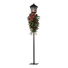 a christmas wreath on top of a lamp post