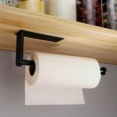 a roll of toilet paper is hanging from a shelf