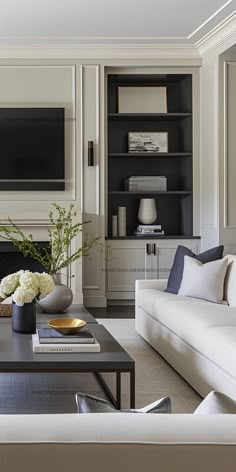 a living room filled with furniture and a flat screen tv mounted on the wall above a fireplace