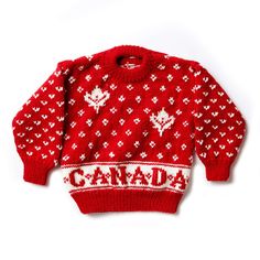 a red and white sweater with the word canada printed on it's chest, in front of a white background