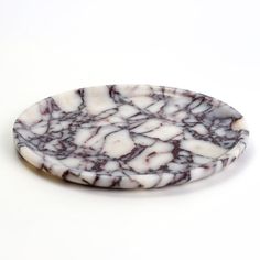 a white and black marble plate sitting on top of a table