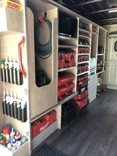 the inside of a garage with tools and other items in it, including hoses