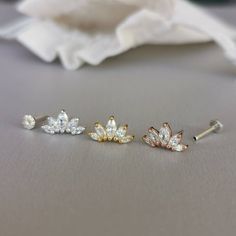 This is a set of a CZ tiara ear piercing jewelry removable end, which has five AAA marquise CZ diamonds, with a threadless push back post.RECOMMENDED WEARING POSITIONEAR PIERCING- Cartilage/Flat - Conch, Inner Conch, Outer Conch- Lobe/Standard Lobe, Upper LobeMATERIAL- AAA Cubic Zirconia- 925 sterling silver with gold/rose gold plated- 925 sterling silver threadless push back postMEASUREMENT* Removable End Size:-- Approximate size : 6.5 mm x 12 mm- CZ size : 1.5 mm x 3 mm, 2 mm x 4 mm, 2.5 mm x Dainty Single Cartilage Earring For Wedding, Dainty White Gold Wedding Piercings, Dainty Cubic Zirconia Wedding Piercings, White Gold Wedding Cartilage Earrings, Sterling Silver Single Cartilage Earring For Weddings, Dainty Wedding Cartilage Earrings With Prong Setting, Delicate Wedding Cartilage Earrings, Tiny Silver Cartilage Earrings For Wedding, Silver Internally Threaded Body Jewelry For Wedding