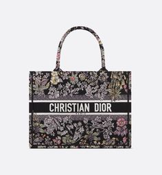 Introduced by Maria Grazia Chiuri, Creative Director of Christian Dior, the Dior Book Tote has become a staple of the Dior aesthetic. Created to hold all the daily essentials, the black style is fully embroidered with the multicolor Millefiori Unicorn motif by Pietro Ruffo, showcasing a symbol from Scottish mythology, the unicorn, within a poetic floral pattern. Adorned with the Christian Dior Paris signature on the front, the medium tote exemplifies the House's savoir-faire and can be carried b Dior Tote Bag, Dior Aesthetic, Dior Book, Flower Handbag, Book Tote Bag, Dior Book Tote, Embroidered Canvas, Maria Grazia Chiuri, Embroidered Tote