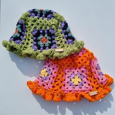 two crocheted hats sitting next to each other