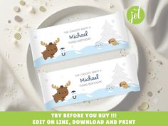 two personalized chocolate bar wrappers with moose and penguin on the snow covered ground