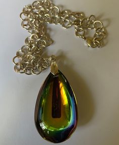 Rainbow Iridescent Pendulum Faux Crystal Necklace Sparkles in a Multiple Color Finish Sparkling Silver-Tone Chain 11" Overall Length 9" Length from Clasp to Bottom of Chain 2" Pendant Few Scratches on Back of Pendant Ships USPS First Class Mail Rainbow Teardrop Jewelry For Party, Rainbow Iridescent, Crystal Pendant Necklace, Rainbow Crystal, Crystal Necklace Pendant, Multiple Color, Crystal Pendant, Crystal Necklace, Beautiful Jewelry