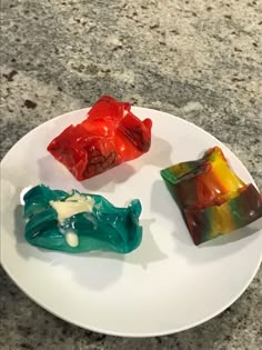 three gummy bears on a white plate