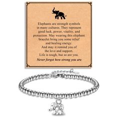 a bracelet with an elephant charm on it and a card that says elephants are strength symbols in many culture