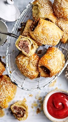 several pastries on a wire rack next to a cup of coffee and saucer