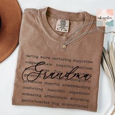 a brown t - shirt with the words grandma written in cursive writing on it