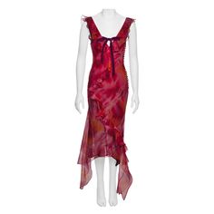 This silk organza dress features a fitted, sleeveless silhouette with a deep V-neckline and an asymmetrical hemline. It showcases vibrant tie-dye colors in red, pink, and orange with abstract, painterly patterns. The dress is adorned with ruffled detailing and a velvet ribbon bow at the centre of the neckline. ▪ Brand: Christian Dior ▪ Creative Director: John Galliano ▪ Collection: Spring-Summer 2001 ▪ Fabric: Silk Organza with Silk Lining ▪ Size: FR40 - UK12 - US8 ▪ Made in: France ▪ Condition: John Galliano Dior Haute Couture, Organza Ruffle Dress, Velvet Ribbon Bow, Silk Organza Dress, Galliano Dior, Dior By John Galliano, Evening Mini Dresses, 20th Century Fashion, Dye Colors