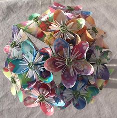 a bunch of paper flowers sitting on top of a table