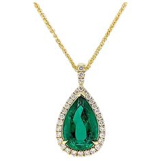 This breathtaking GIA certified Pear Shape Emerald is encircled with 31 natural round cut diamonds mounted on 18K Yellow Gold. The necklace is hand crafted with meticulous attention to details and can compliment any outfit. Jewel Details: 4.32 Carat Pear Shape Emerald 31 round cut diamonds 0.44 total carat weight F-H color, VVS clarity. 18 K Yellow Gold The pendant comes with a yellow gold necklace. Pear Shape Pendant, Pear Shaped Pendant, Pear Pendant, Yellow Gold Necklace, Emerald Pendant, Pear Shape, Round Cut Diamond, Pear Shaped, The Necklace