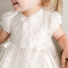 Handmade in the USA This girls Baptism gown is so gorgeous and so detailed, it's not a stretch to say that it is truly a work of art. The lace overlay on this baptism gown is both stunning and special, made of embroidered netting with a rich floral design featuring embroidered flowers in a pretty shade of ivory with champagne cording, adding depth and richness. Trimmed in ivory Venice edging and long ivory silk ribbon bows flowing down the skirt. Includes the matching sheer lace bonnet. This bea Lace Ball Gown With Intricate Embroidery, First Communion Gown With Lace Trim, Fitted Tulle Gown For Confirmation, Fitted Lace Bodice Dress For First Communion, Fitted Lace Bodice Dress For Confirmation, Ceremony Dress With Intricate Embroidery And Fitted Bodice, Elegant Baptism Dress With Lace Trim And Organza, Fitted First Communion Dress With Lace Sleeves And Tulle, Tulle Dress With Fitted Bodice For Baptism