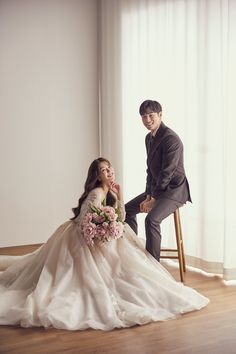 a bride and groom sitting on a chair