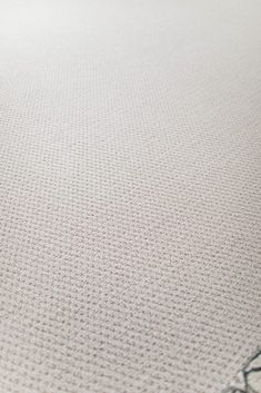 a close up view of a white rug with black writing on the top and bottom