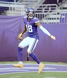 a football player running on the field with his foot in the air and one hand out