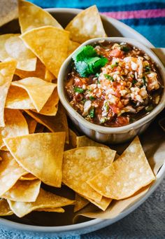 tortilla chips and salsa in a bowl on a table