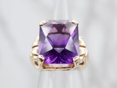 This stunning yellow gold ring is set with a single amethyst, making the perfect solitaire cocktail ring. The gold provides a luxurious shine and the amethyst exudes a deep, regal color. Be the center of attention with this eye-catching ring.Metal: 14K Yellow GoldGem: Amethyst 18.52 CaratsGem Measurements: 14.8 x 20.3 mm, Emerald CutRing Size: 7.50Marks: "14K" Stamped on the inside band Center Of Attention, Ring Metal, Yellow Gold Ring, Cocktail Ring, Yellow Gold Rings, Cocktail Rings, Gold Ring, Gold Rings, Emerald