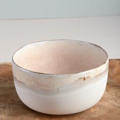 a white bowl sitting on top of a wooden tray