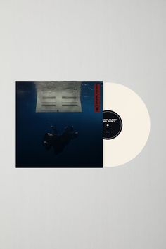 a white vinyl record with an image of a person swimming in the water