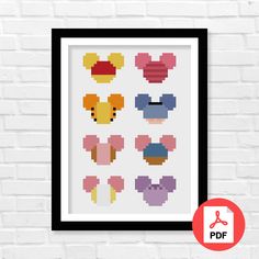 a cross stitch pattern with mickey mouse heads in different colors and sizes on a white brick wall