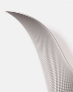 a close up view of the side of a white surfboard with wavy lines on it