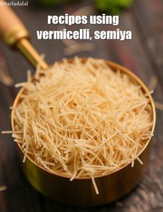 a wooden bowl filled with shredded cheese on top of a table