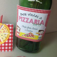 a bottle of wine next to a piece of pizza on top of a red and white checkered table cloth