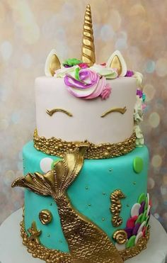 a multi - layer cake decorated with an unicorn's face and gold sequins