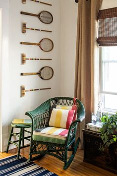 a room with some tennis rackets hanging on the wall next to a chair and table