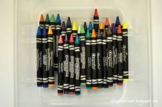 several different colored crayons in a plastic container