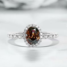 a ring with a large brown diamond surrounded by white diamonds