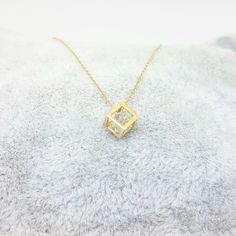 - Cube pendant necklace is made with high-quality 14K real solid gold. - The Inside of the cube, there is a diamond cut cubic zirconia stone and it is moving. - The dimensions of the cube is 0.5 X 0.5 X 0.5 cm. - This dainty, charm, tiny, delicate, cute and trendy pendant necklace has been artfully designed for timeless yet modern millennial fashion. - This 14K solid gold pendant comes with a beautiful matching free 14K real solid gold chain. - You receive the pendant in a beautiful and free gif Trendy Pendant Necklace, Millennial Fashion, Gold Cube, Dainty Pendant Necklace, Snowflake Bracelet, Tiny Necklace, Cube Necklace, Artfully Designed, Tiny Charm