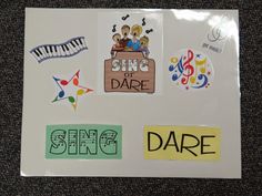 some stickers are on top of a piece of paper that says sing or dare