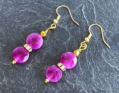 Sugilite earrings: two flat round faceted beads 10-10.5mmx5-6 mm, one 18K gold-plated rhinestone rondelle, one 18K gold-plated faceted bead 4 x 3.5 mm; with 18K gold-plated brass the sugilite is naturally uncolored Sugilite earrings / jewelry / Sugilite earrings / yoga / Sugilite beads / delicate beads / real Sugilite jewelry / purple violet / purple Sugilite earrings / purple violet earrings / purple Sugilite beads / purple earrings / purple jewelry Gold Earrings With Gemstone Beads, Violet Earrings, Sugilite Jewelry, Jewelry Purple, Purple Jewelry, Earrings Purple, Purple Earrings, Purple Violet, Violet Purple