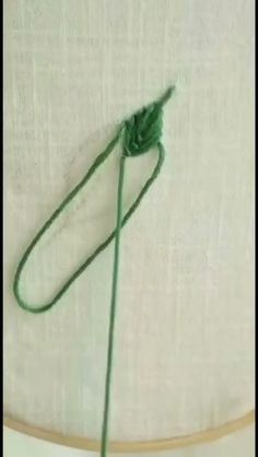 a piece of green string is tied to the wall